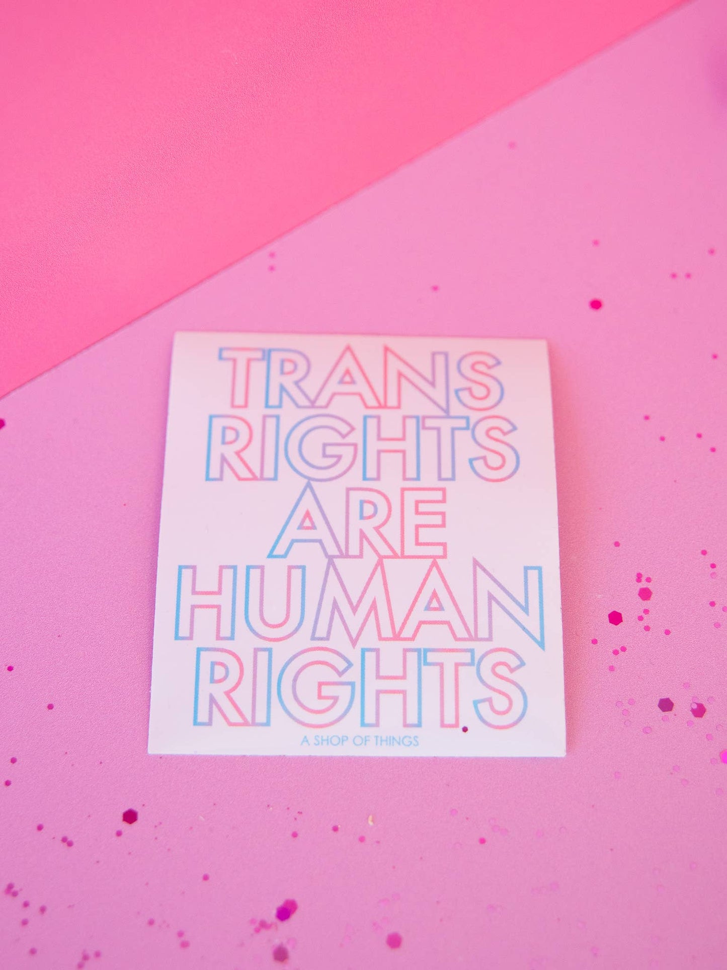 Sticker with 'Trans Rights Are Human Rights' text on a pink background