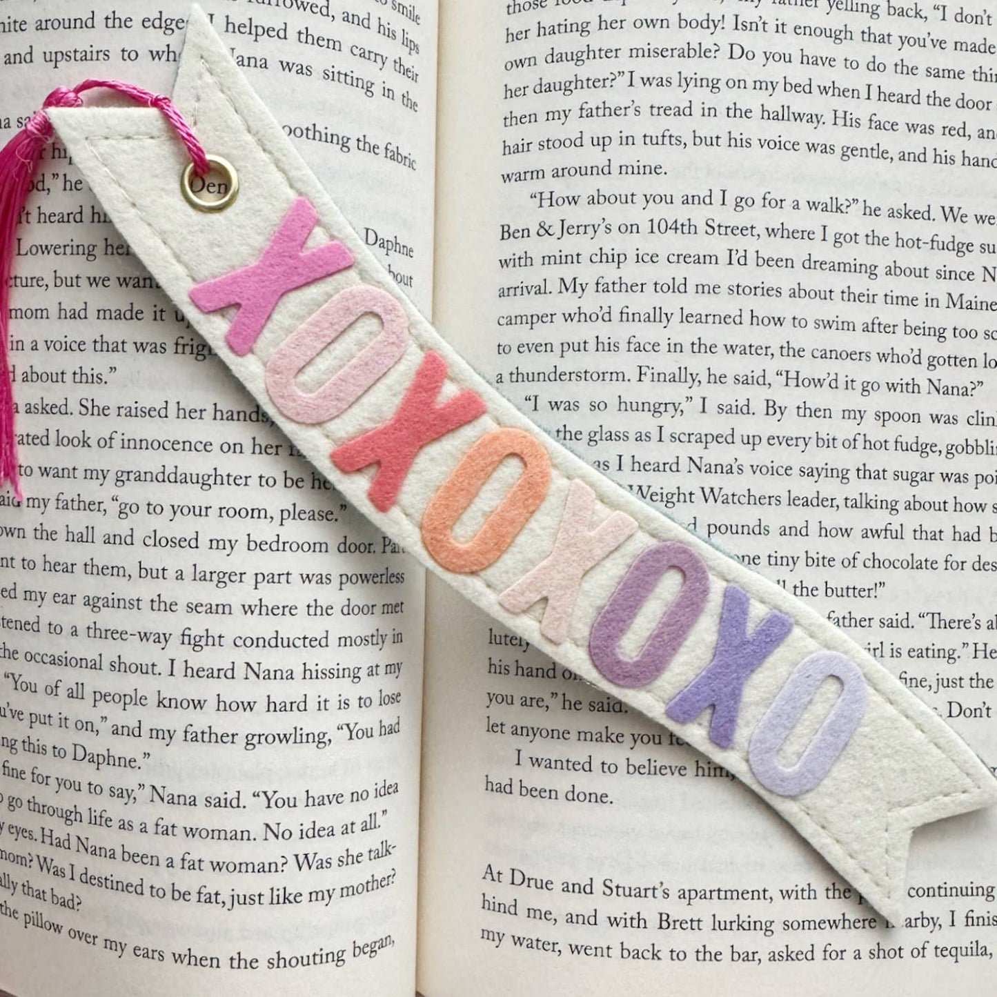Bookmark with colorful letters 'XO' on an open book