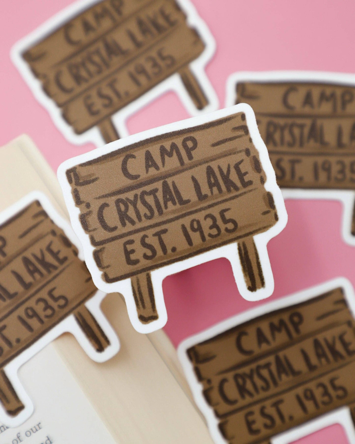 Sticker of 'Camp Crystal Lake Est. 1935' on a pink background