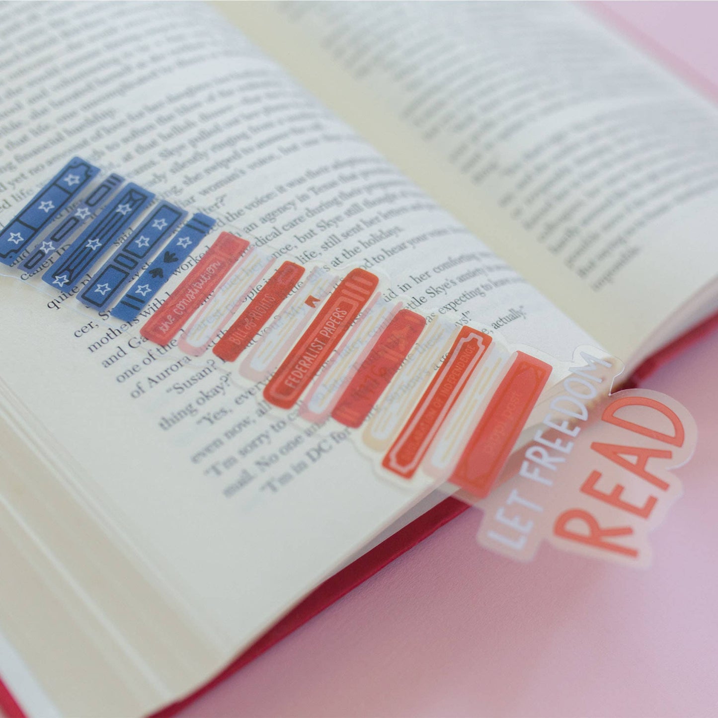 Open book with colorful bookmarks and a clear bookmark with 'Let Freedom Read' text.