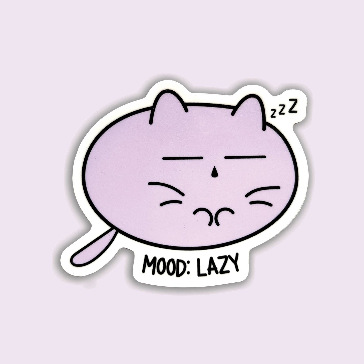 A die-cut sticker featuring a cartoon purple cat sleeping with closed eyes and the text 'MOOD: LAZY' and 'zzz', shown on a pale lavender background.