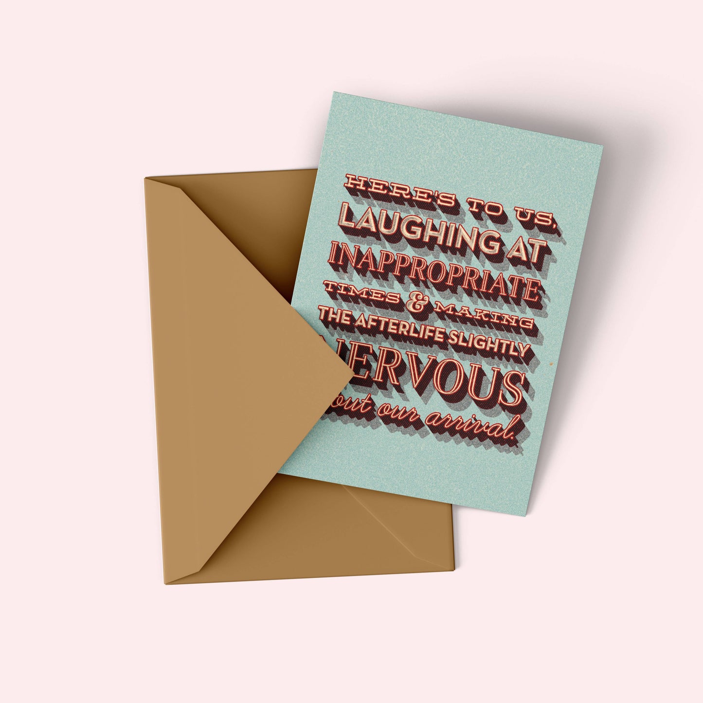 Greeting card with humorous text and gold envelope on a light background