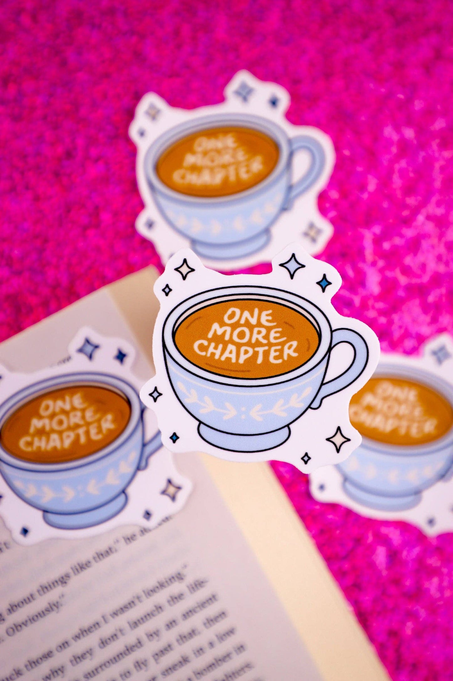 Bookmarks with 'One More Chapter' text on a pink background