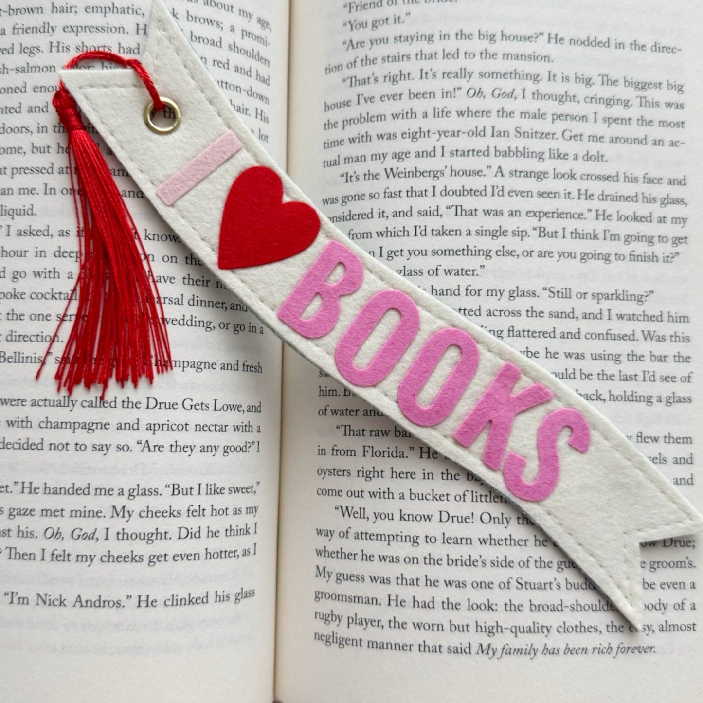 Bookmark with 'I love books' text and red heart on an open book