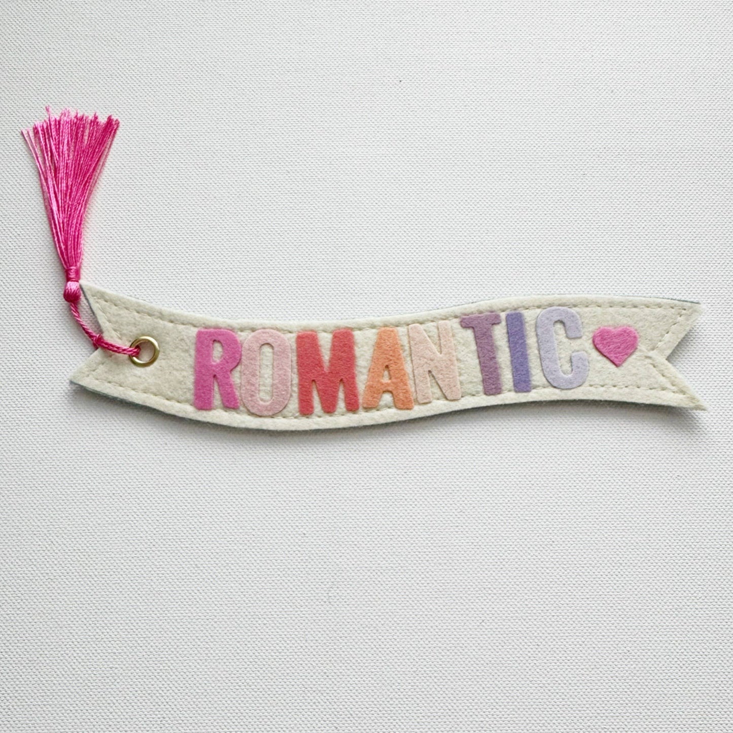Banner-shaped bookmark with 'ROMANTIC' text and a pink heart on a light gray background