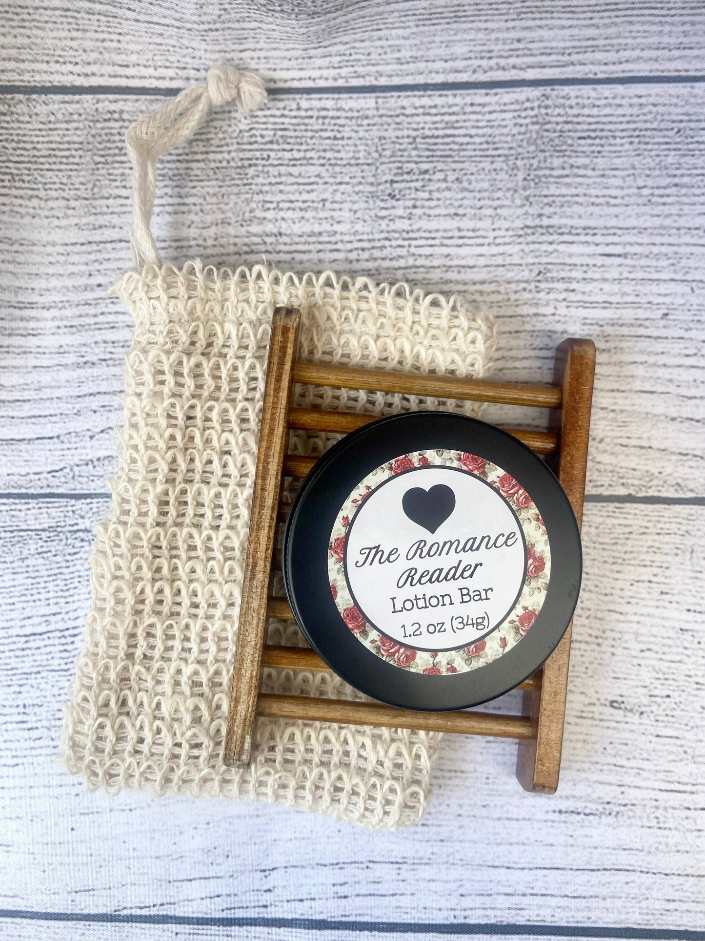 Lotion bar with a decorative label on a wooden stand, accompanied by a textured bag on a wooden surface.