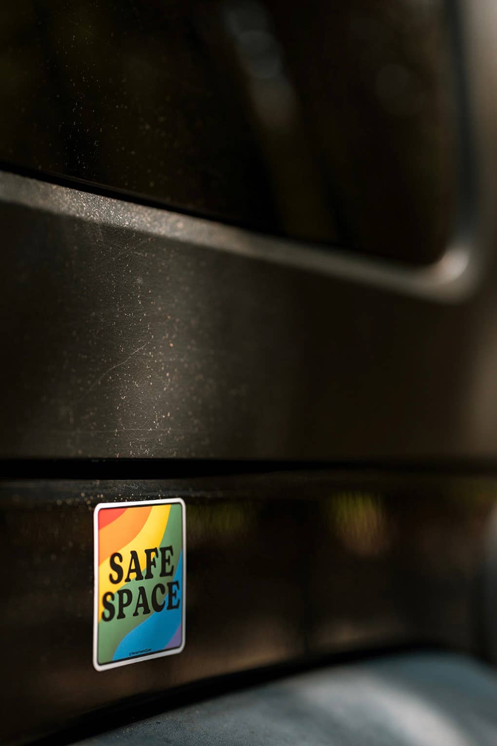 Colorful 'Safe Space' sticker on a dark surface