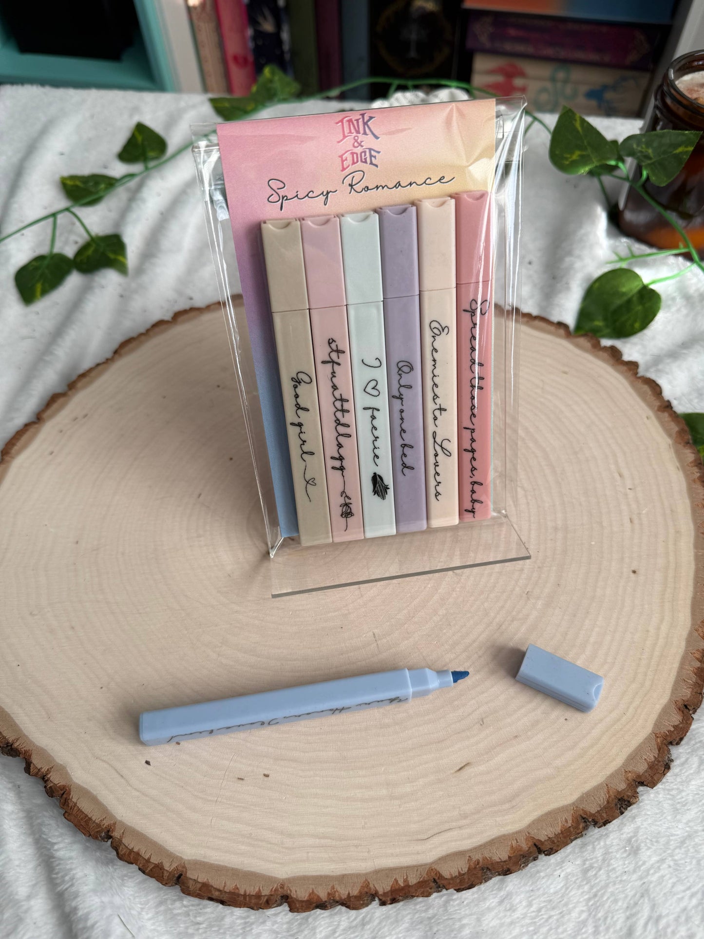 Set of colorful sticky notes with a pen on a wooden surface