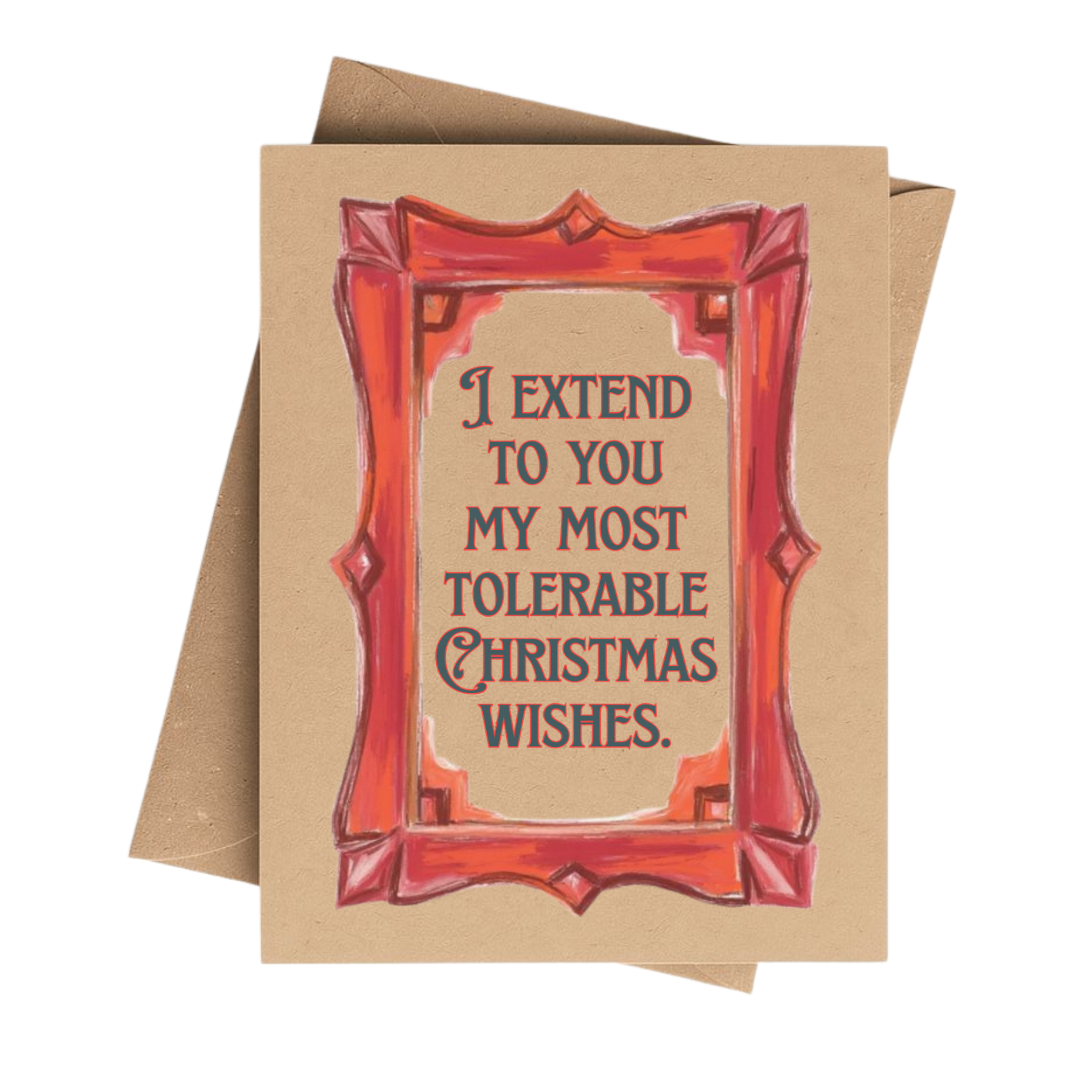 A square kraft paper greeting card with a red illustrated frame and the text 'I EXTEND TO YOU MY MOST TOLERABLE CHRISTMAS WISHES.' A brown envelope is partially visible behind the card on a white background.
