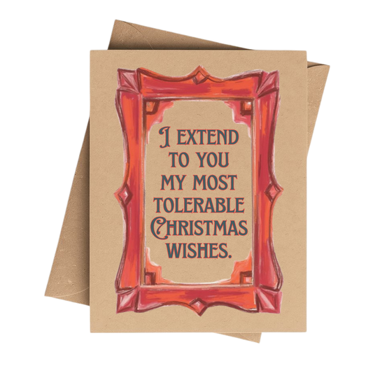 A square kraft paper greeting card with a red illustrated frame and the text 'I EXTEND TO YOU MY MOST TOLERABLE CHRISTMAS WISHES.' A brown envelope is partially visible behind the card on a white background.