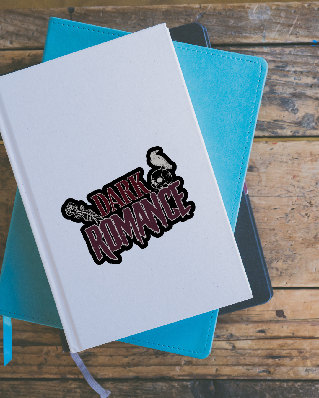 Notebook with 'Dark Romance' design on a wooden surface