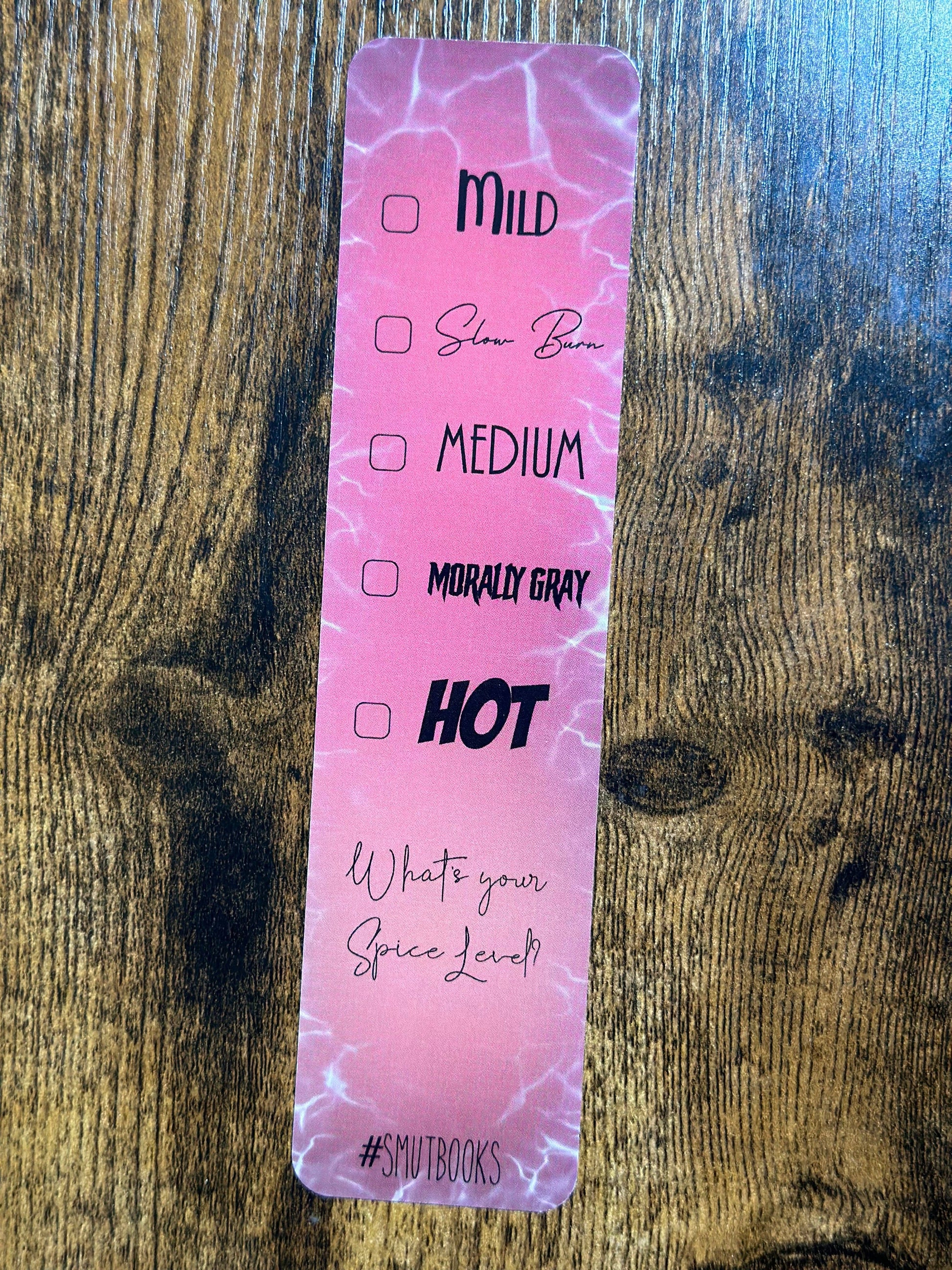 Pink label with text on a wooden surface