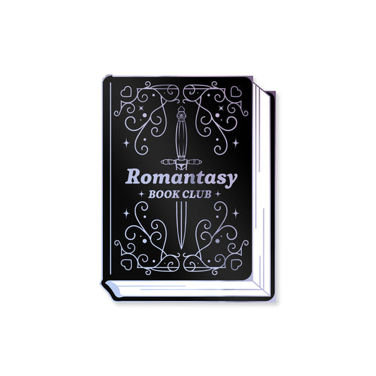 A book-shaped accessory with a black cover and white decorative line art featuring a sword and the text 'Romantasy BOOK CLUB'.