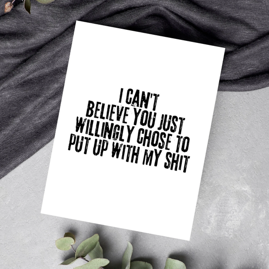 White card with black text on a gray fabric background