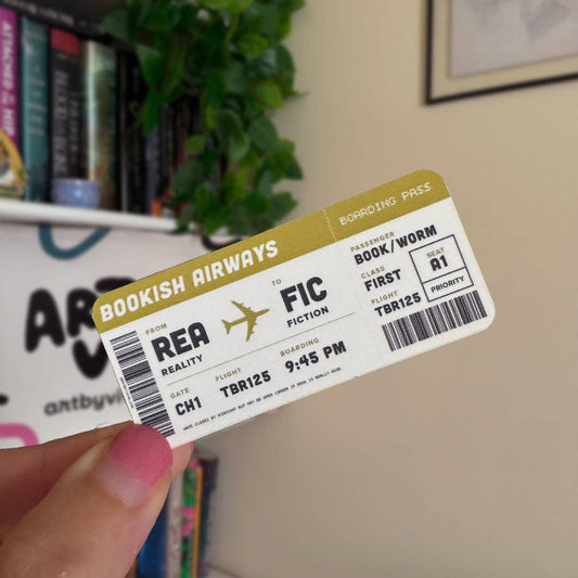Book-themed boarding pass held by a hand with books and a plant in the background