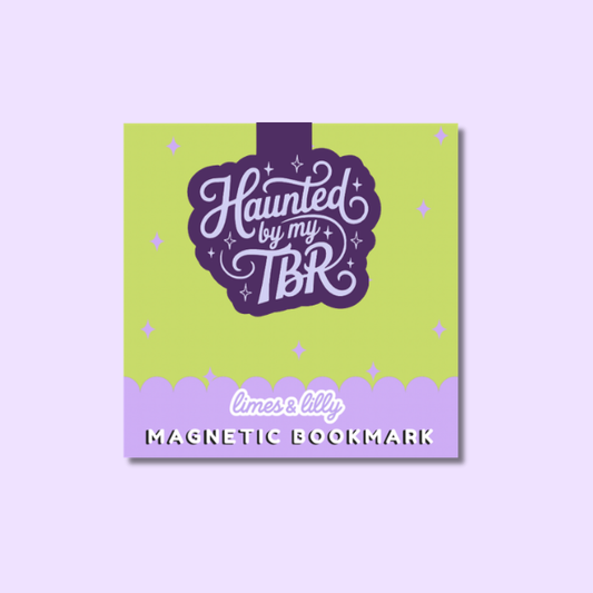 A square magnetic bookmark card with a lime green top section and a lavender bottom banner. The center features a dark purple label with the phrase 'Haunted by my TBR' in stylized white script, surrounded by small white stars.