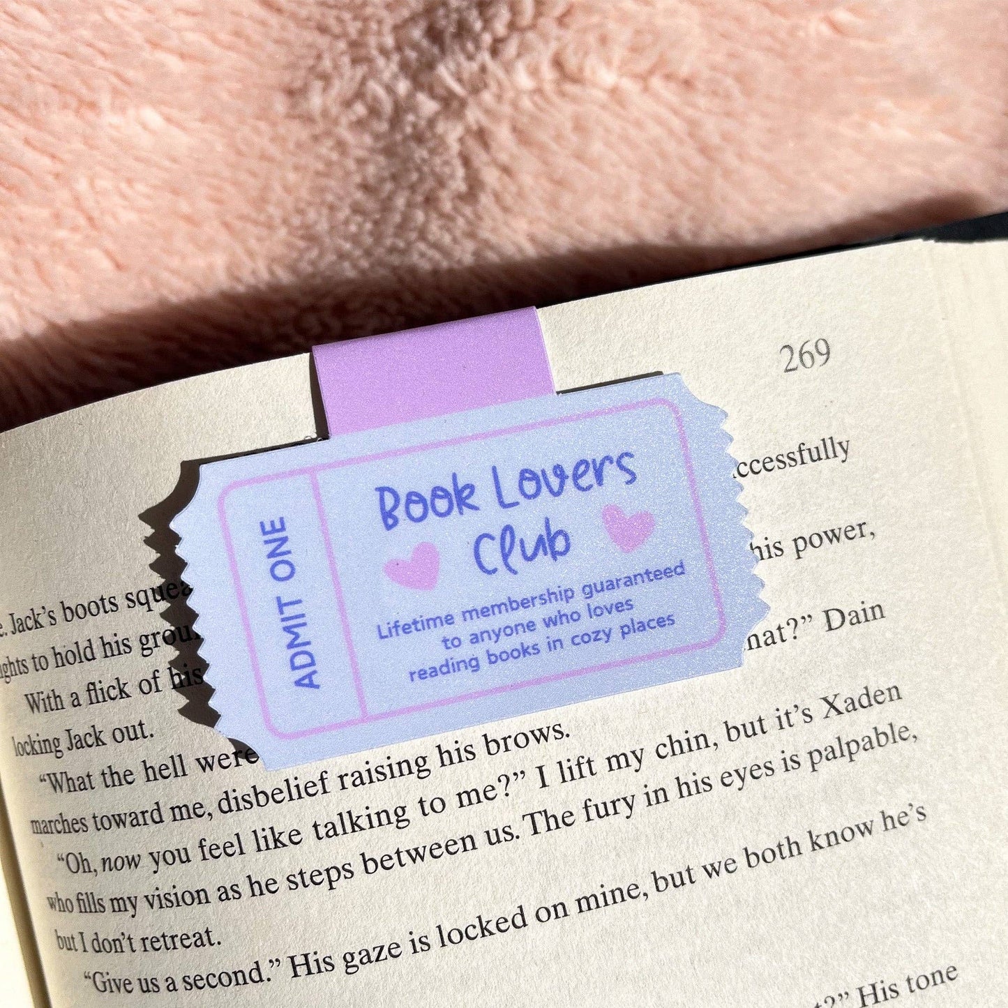 Book with a 'Book Lovers Club' bookmark on a textured surface