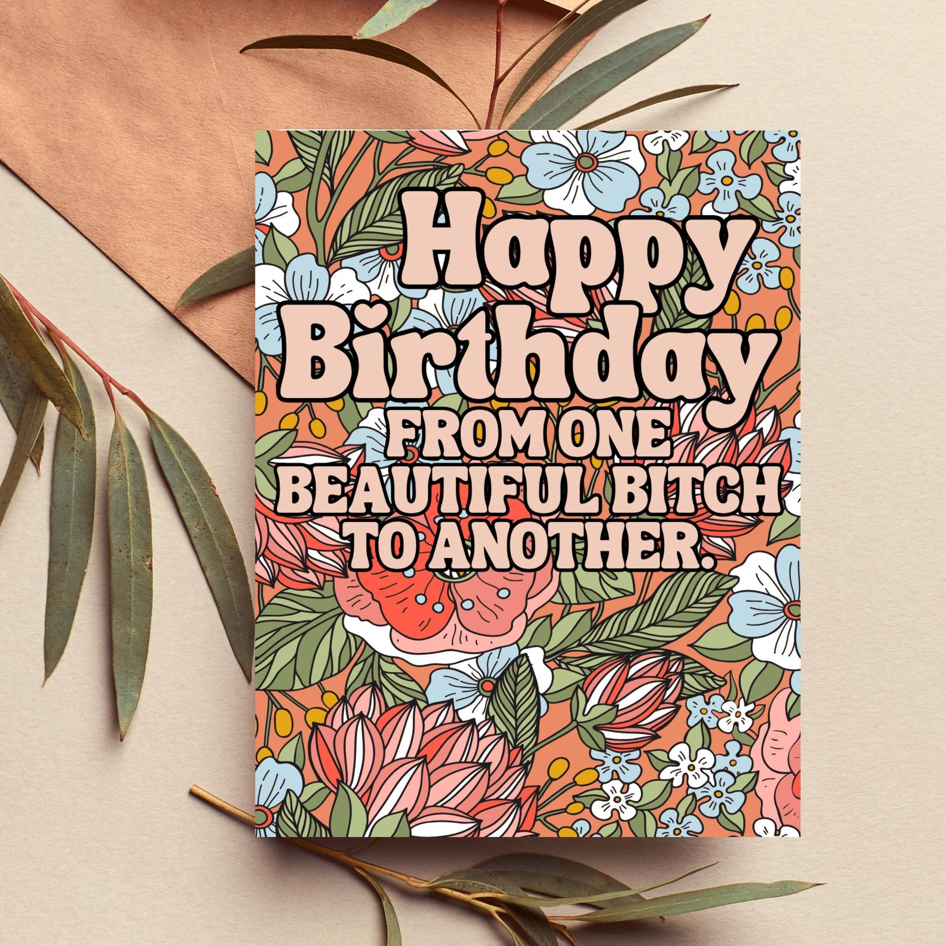 Colorful birthday card with floral design and humorous text on a beige background.