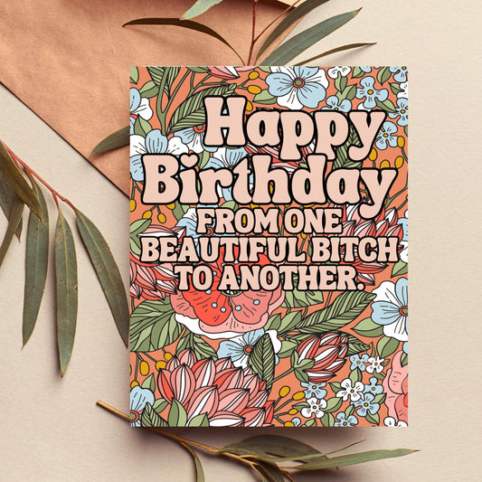 Colorful birthday card with floral design and humorous text on a beige background.