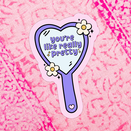 Sticker of a hand mirror with 'you're like really pretty' text on a pink textured background