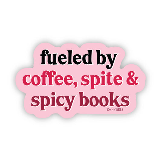 Pink sticker with text 'fueled by coffee, spite & spicy books' on a white background