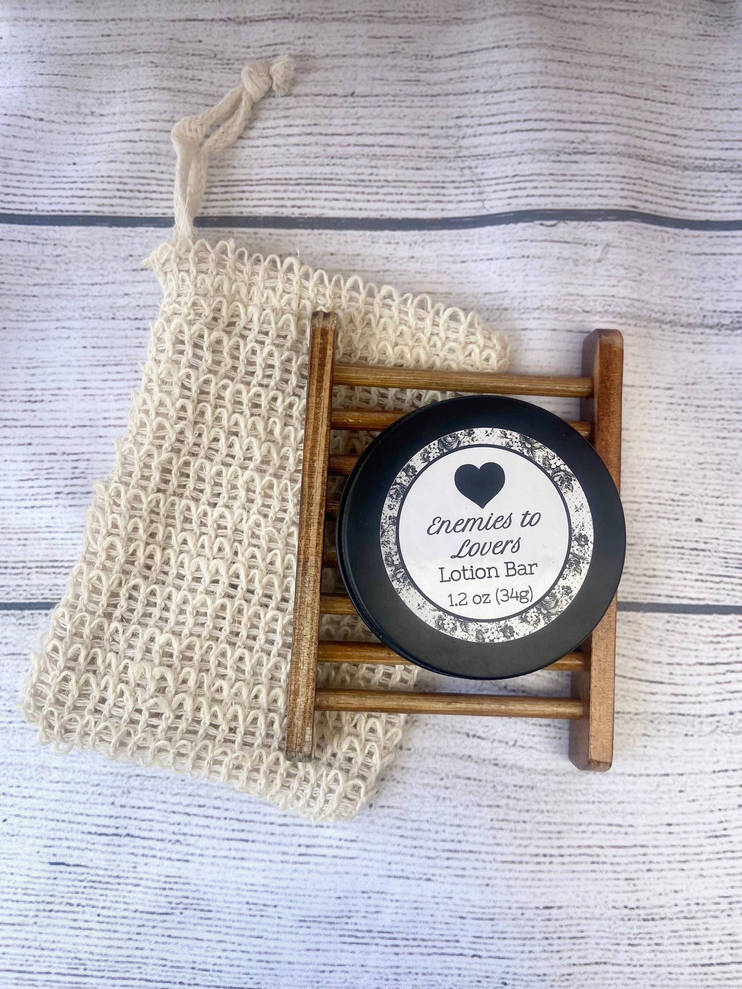 Lotion bar with a label on a wooden stand, next to a washcloth on a textured surface