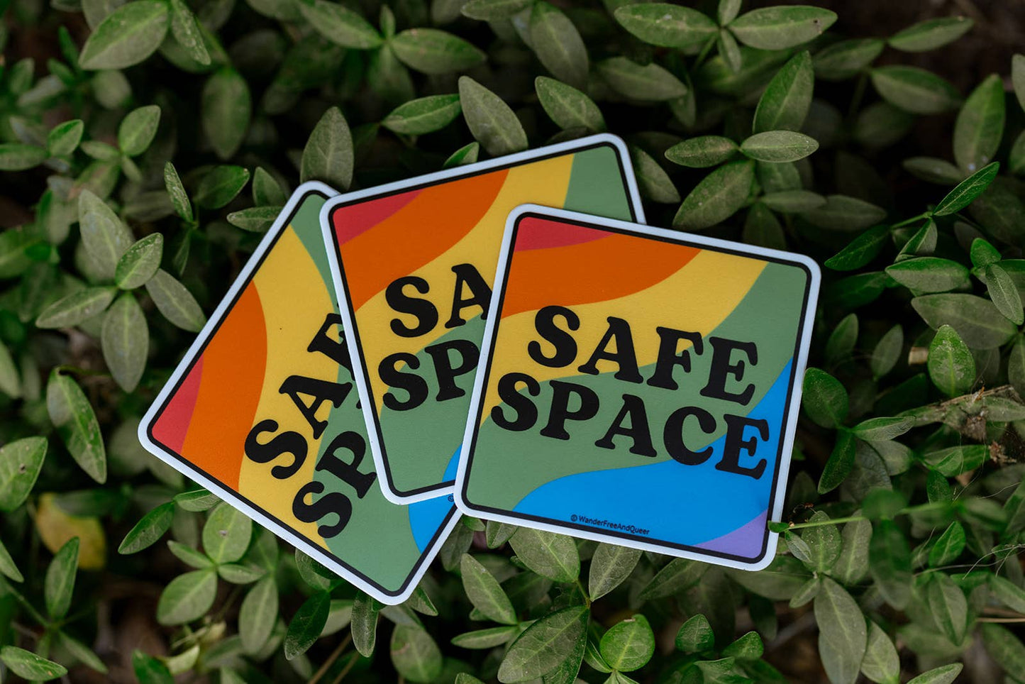 Three 'Safe Space' stickers on a leafy background