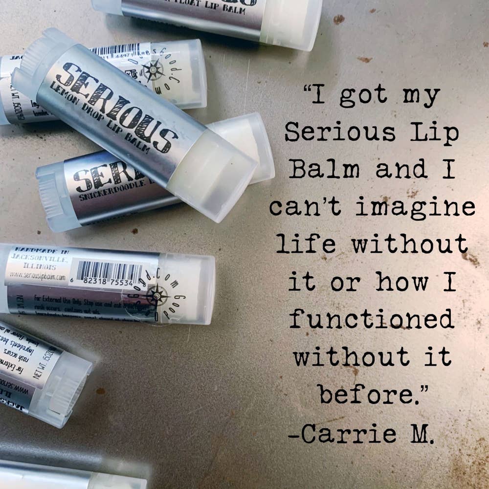 Multiple tubes of 'Serious' lip balm on a textured surface with a quote attributed to Carrie M.