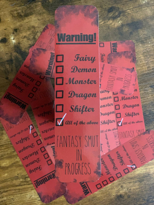 Red bookmarks with text and checkboxes on a wooden surface