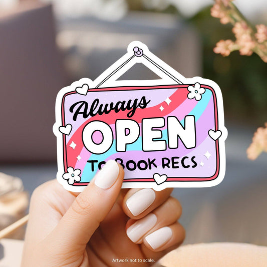 Sticker with 'Always Open to Book Recs' text held by a hand with white nail polish.