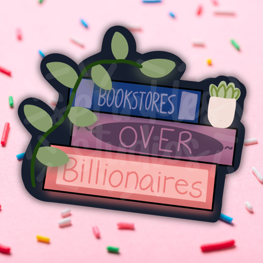 Decorative sign with text 'Bookstores Over Billionaires' on a pink background with colorful confetti.
