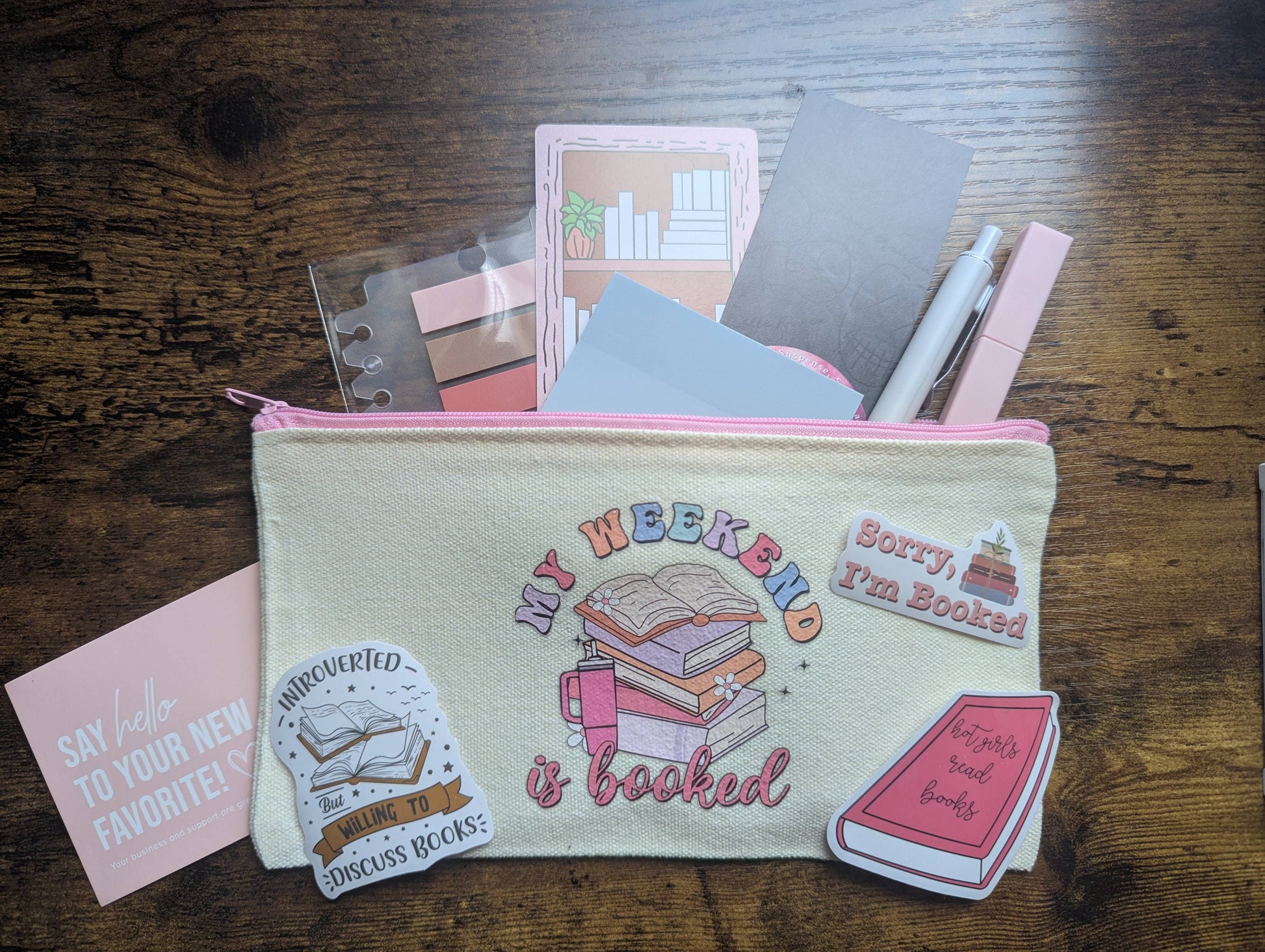 Pouch with stationery items on a wooden surface