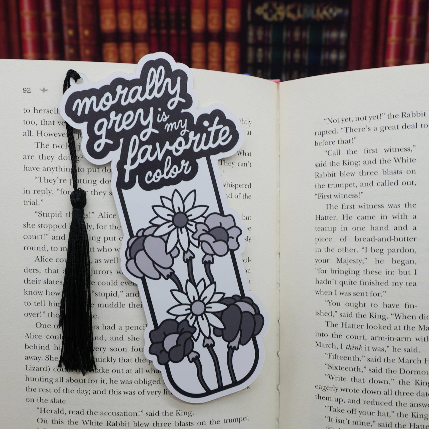 Decorative bookmark with flowers and text on an open book