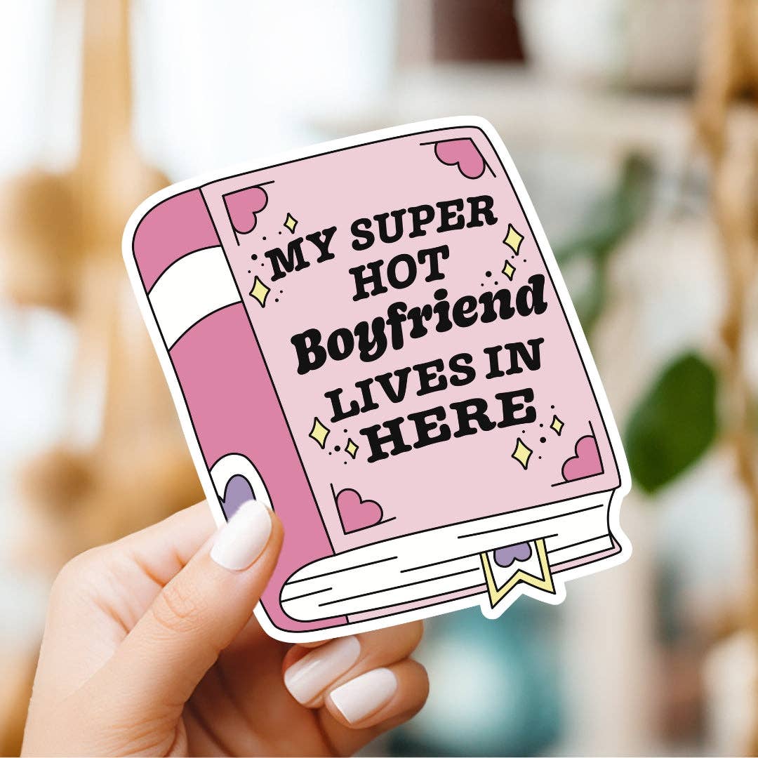 Sticker with text 'My Super Hot Boyfriend Lives In Here' held by a hand.