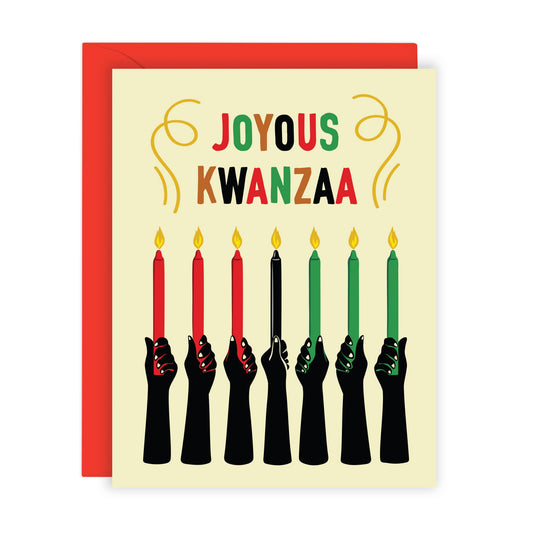 A Kwanzaa greeting card with a red envelope, featuring the words 'JOYOUS KWANZAA' above seven black hands holding candles in red, black, green, and yellow colors on a cream background.
