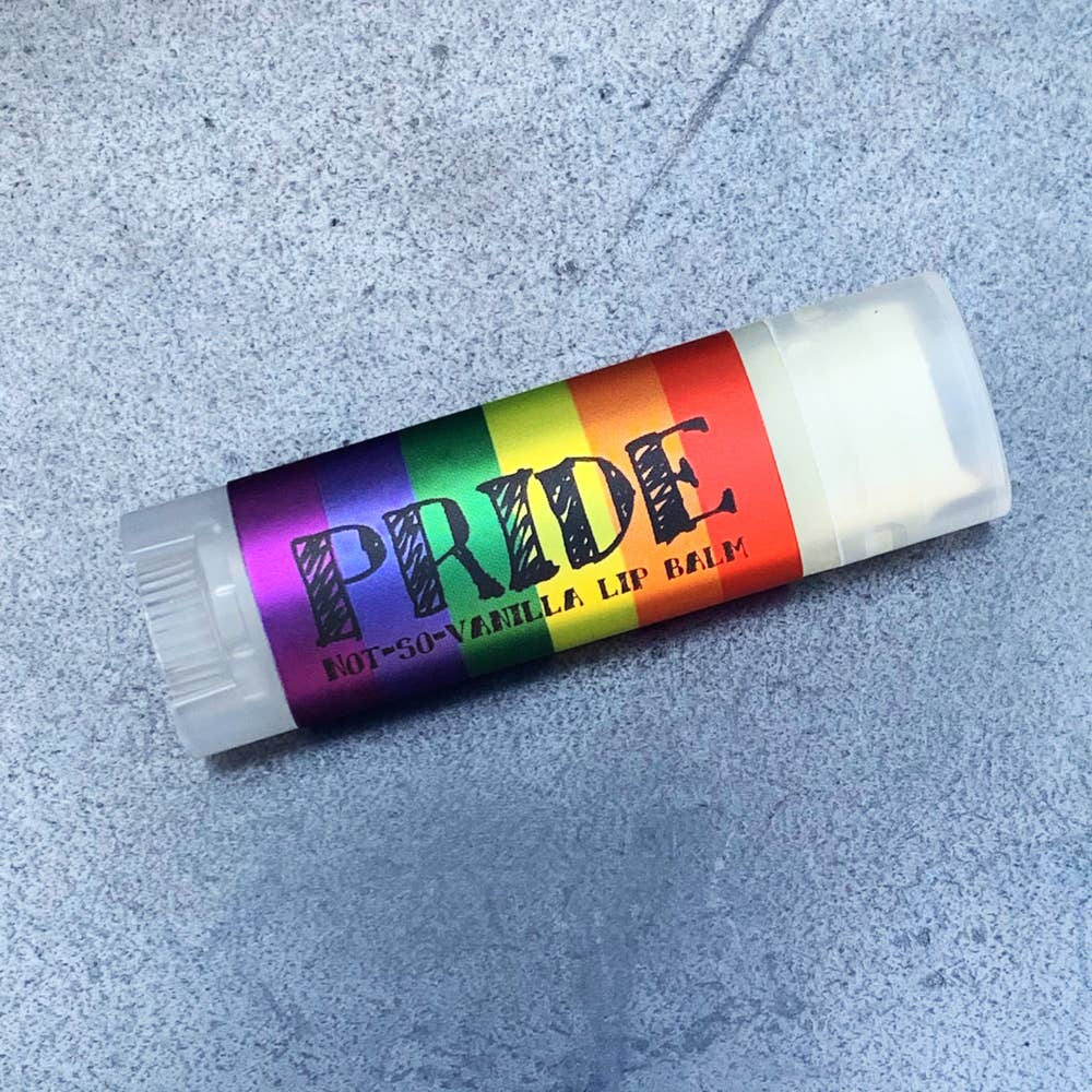 Lip balm with rainbow label on a gray surface