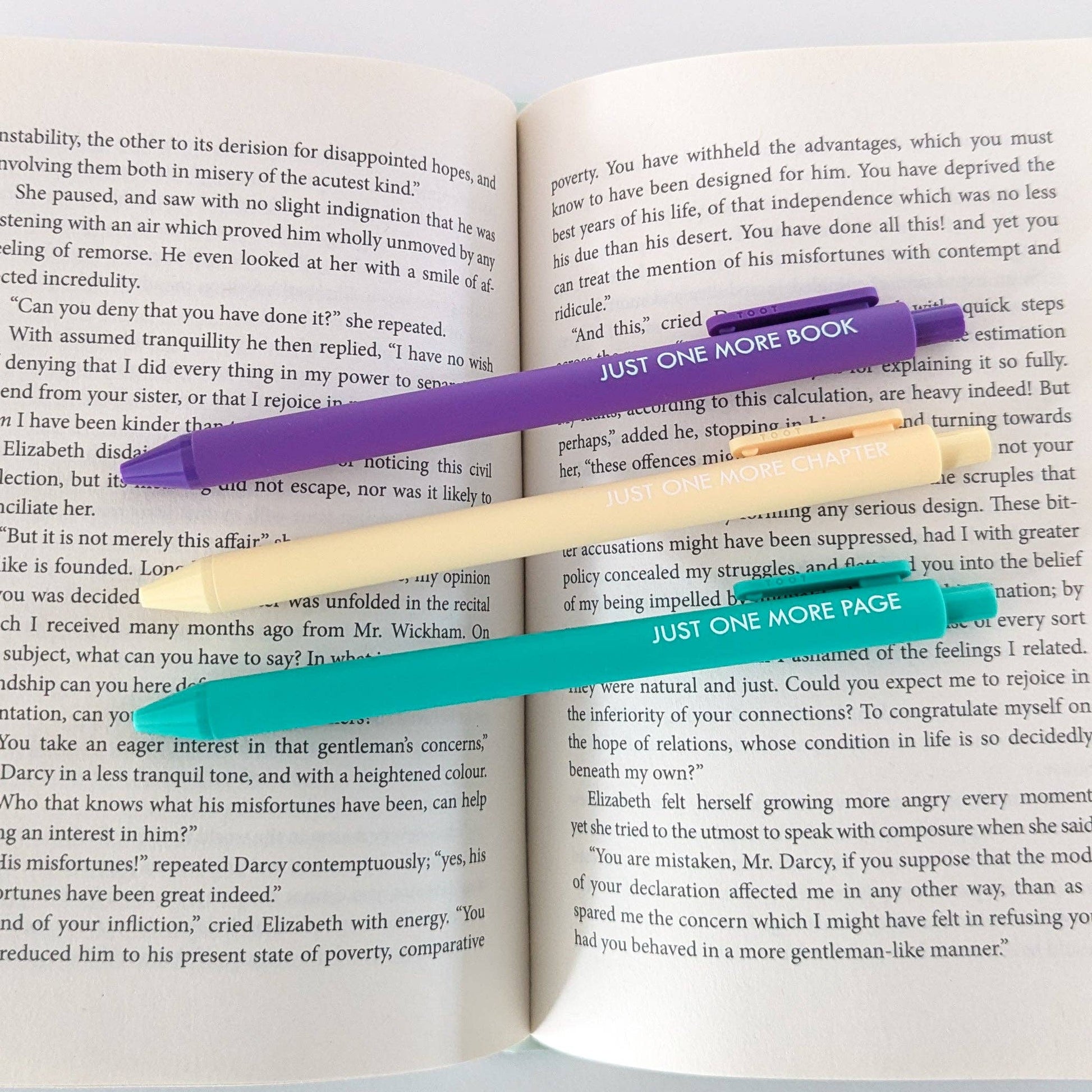 Three bookmarks with text on an open book