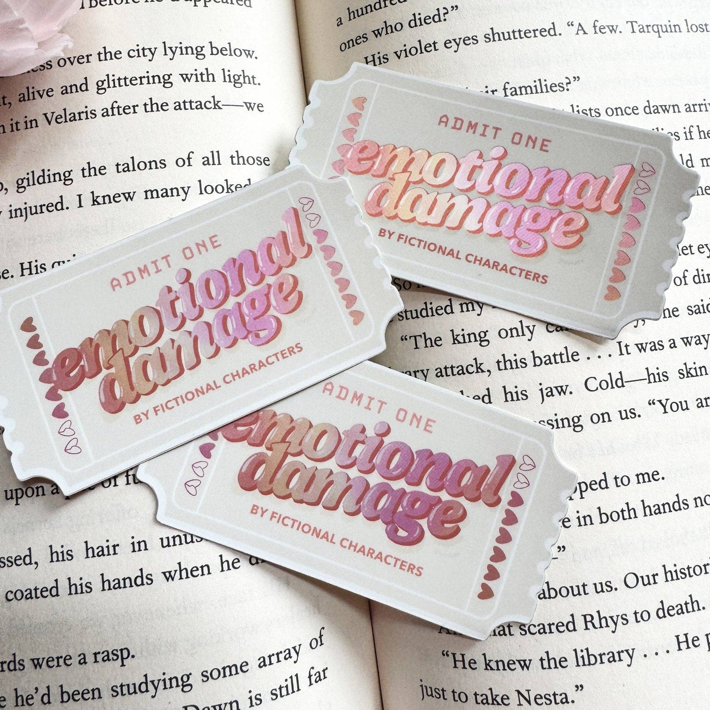 Tickets labeled 'Emotional Damage by Fictional Characters' on top of a book