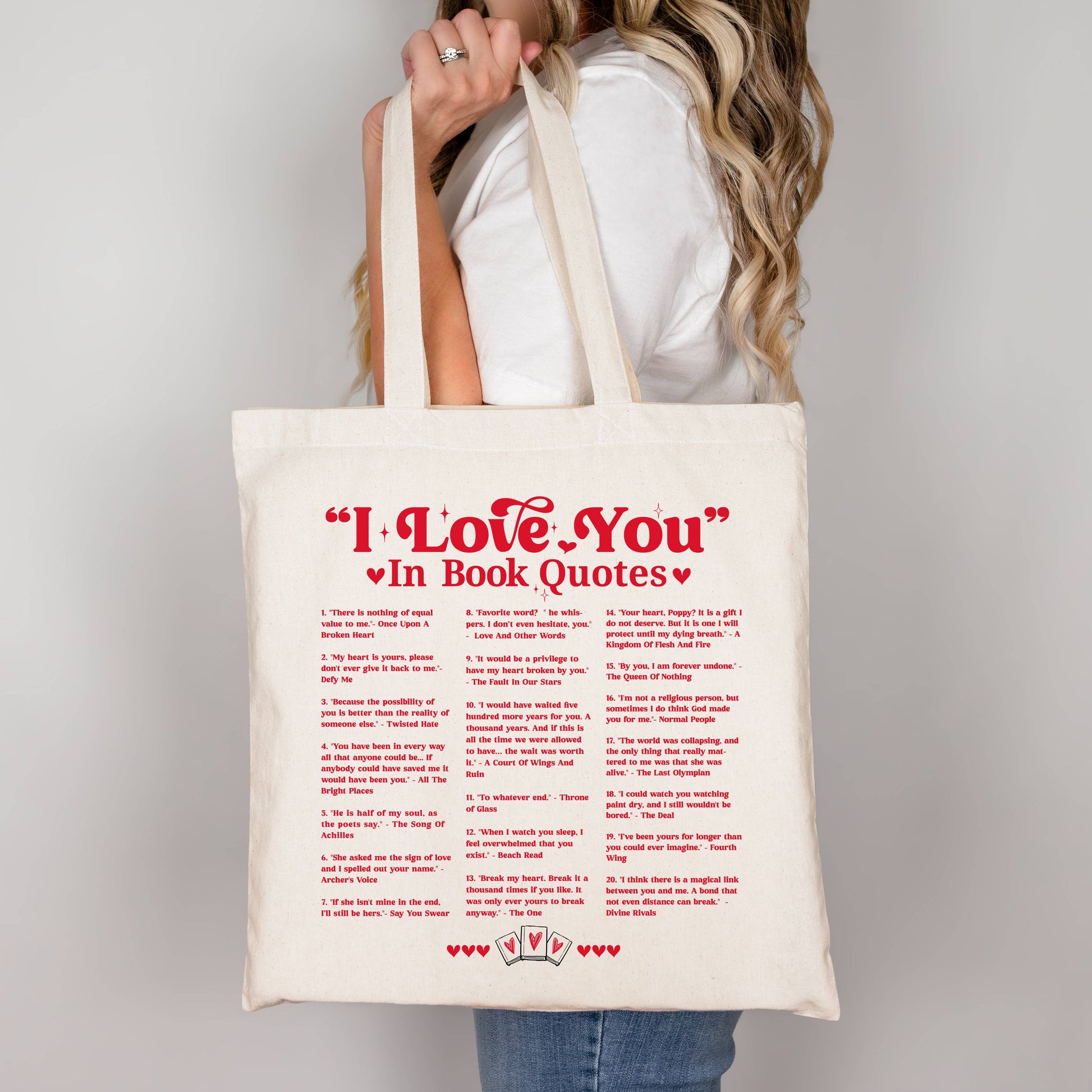 Tote bag with 'I Love You' in Book Quotes text held by a person against a plain background