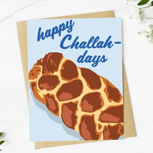 Greeting card with a loaf of bread illustration and 'happy Challah-days' text on a light blue background.