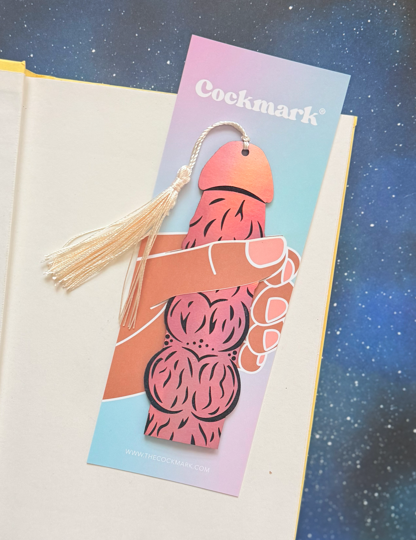 Bookmark with tassel and 'Cockmark' branding on a starry background