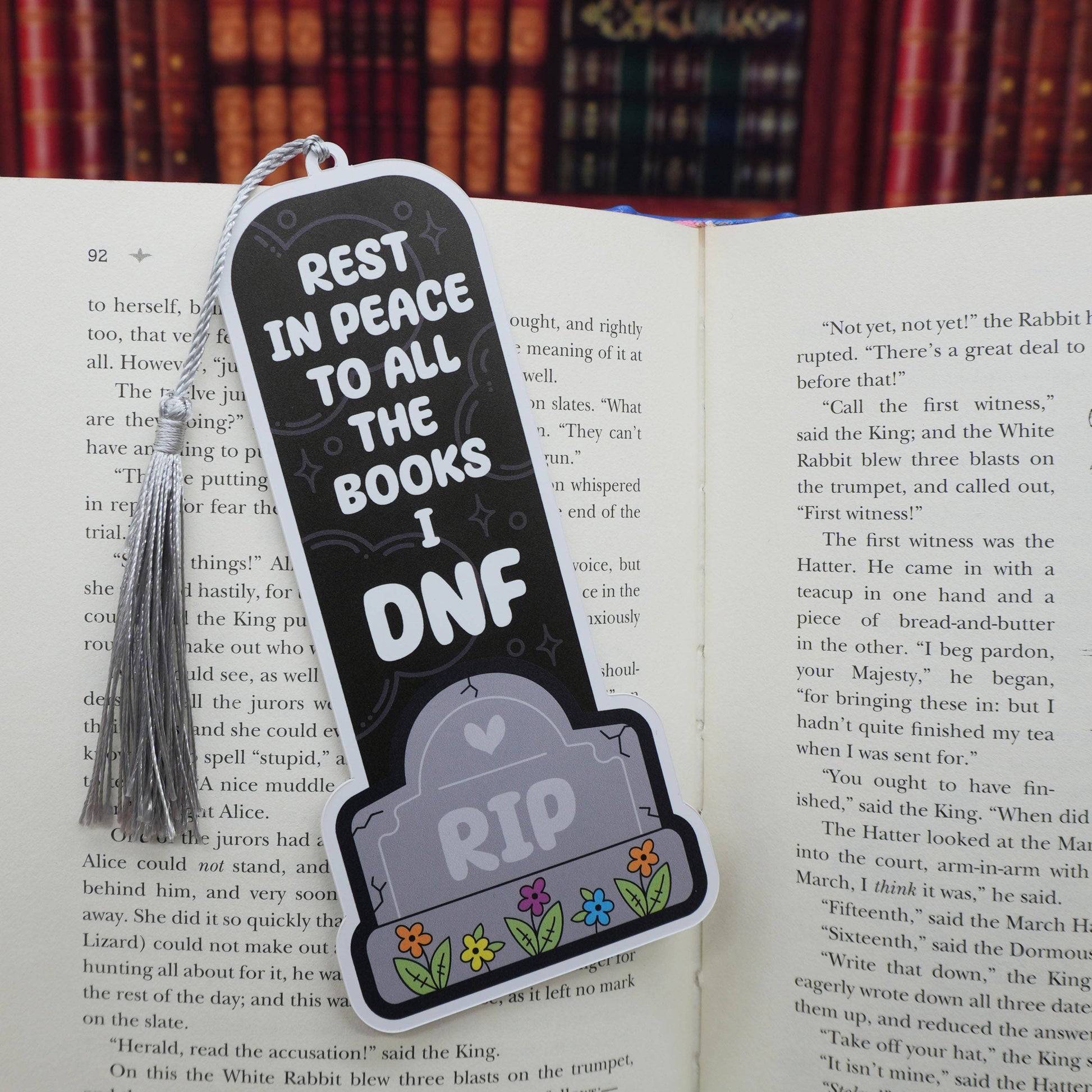 Bookmark with 'Rest in Peace to all the books I DNF' text on an open book.