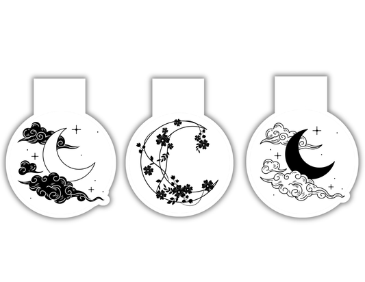 Three decorative items with crescent moon and floral designs on a white background