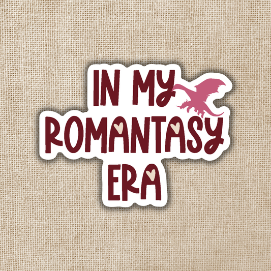 Sticker with 'In My Romantasy Era' text on a textured beige background