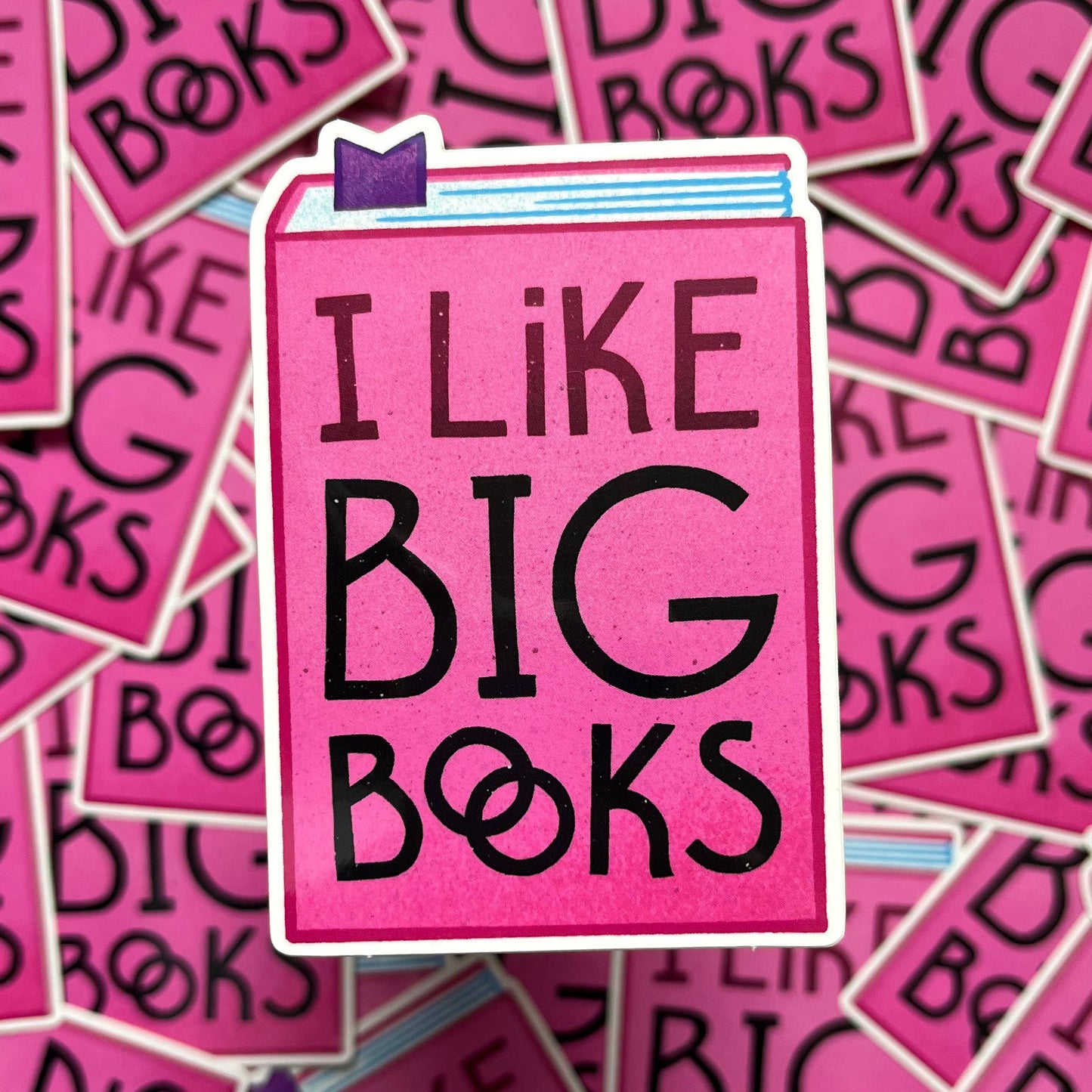 Pink sticker with 'I Like Big Books' text on a background of similar pink stickers.