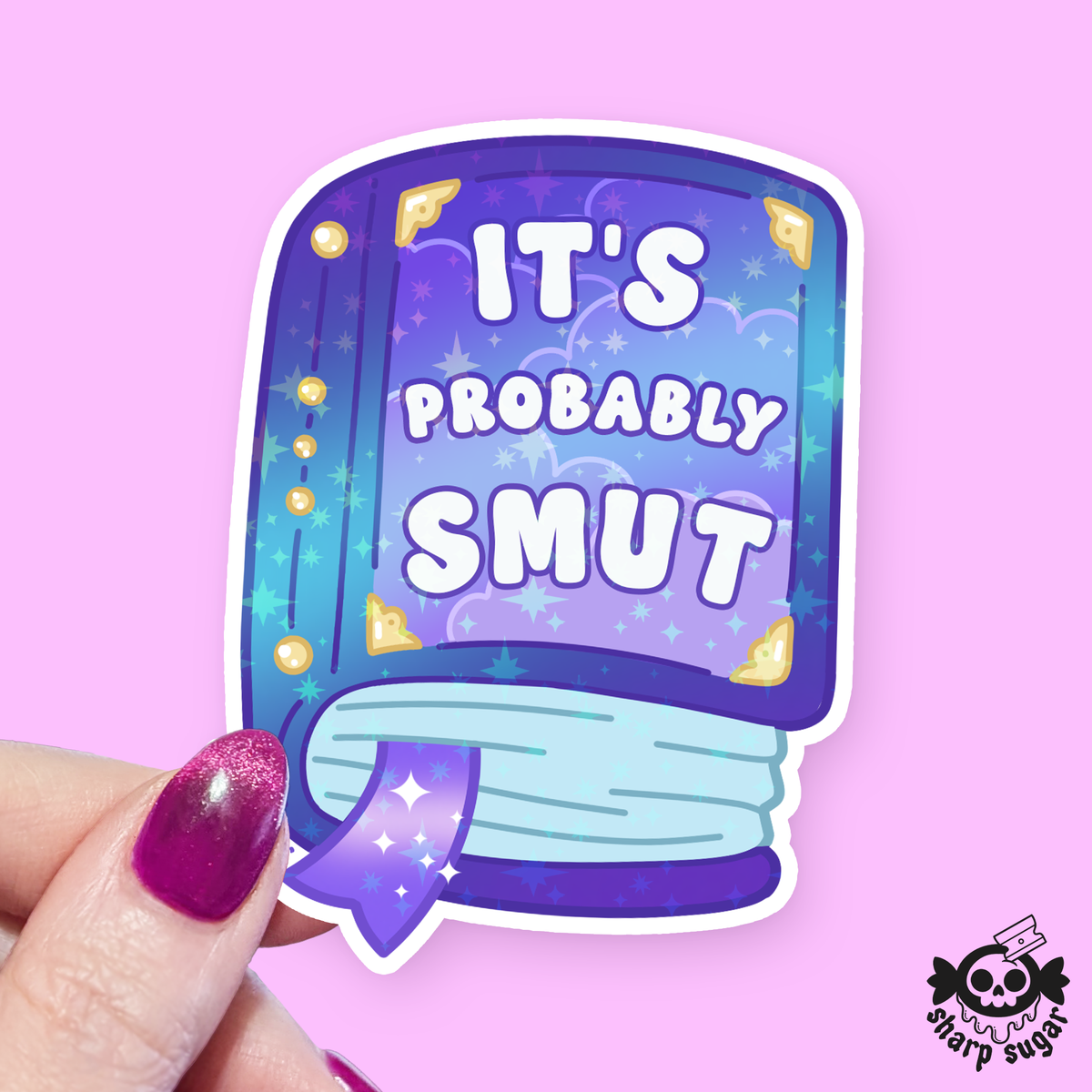 A die-cut sticker shaped like a book with the text 'IT'S PROBABLY SMUT' in white lettering on a purple and blue illustrated cover, held by a hand with glittery purple nail polish against a solid pink background. A 'sharp sugar' brand logo is visible in the bottom right corner.