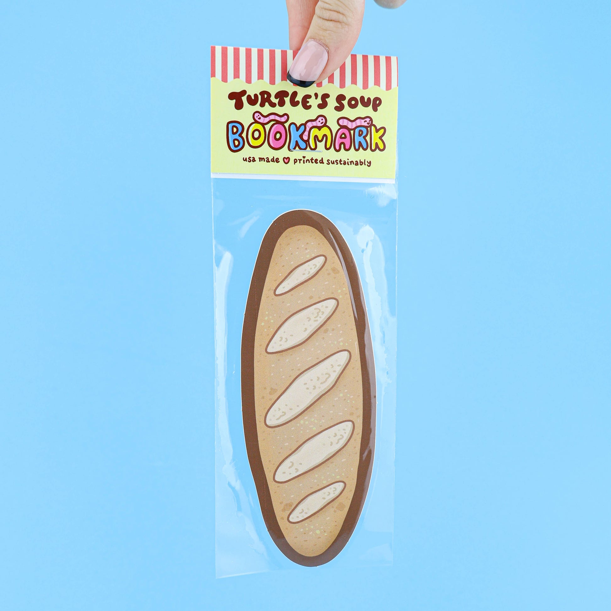 Bookmark shaped like a loaf of bread in clear packaging with 'Turtle's Soup' branding on a blue background.