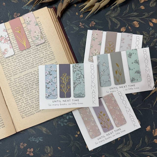 Set of floral bookmarks on an open book with a decorative background