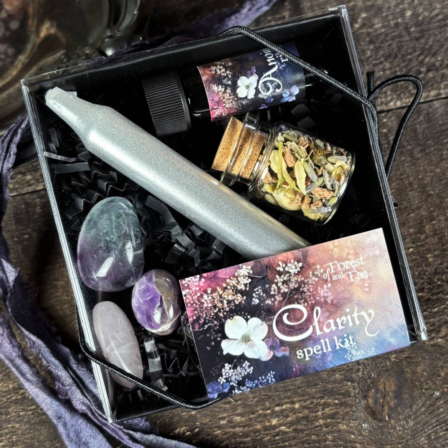 Clearance spell kit with candle, crystals, and herbs on a wooden surface