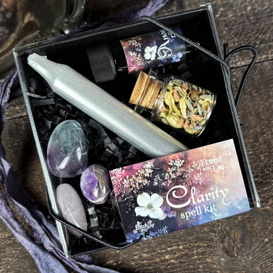 Clearance spell kit with candle, crystals, and herbs on a wooden surface